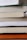 A close-up of a stack of colorful printed books on a wooden table.
