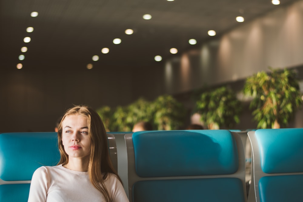 woman sitting on gray and blue gang chair