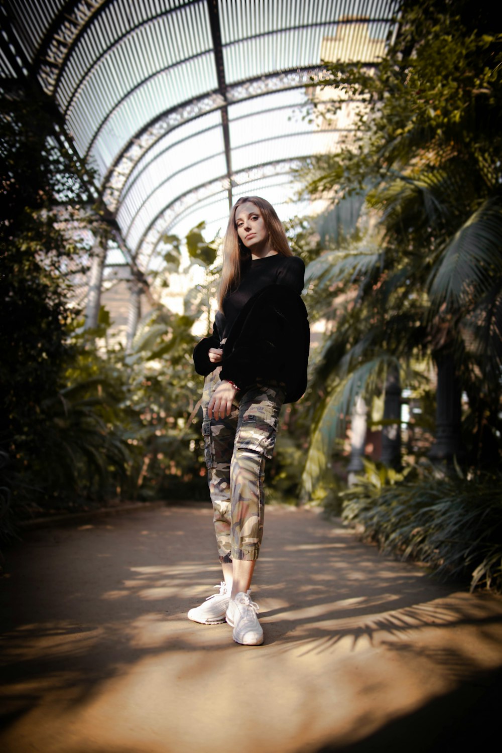 woman standing beside plants