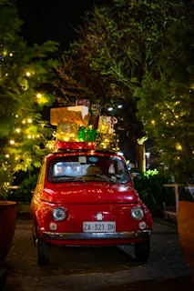 classic red FIAT 500 with christmas boxes on top