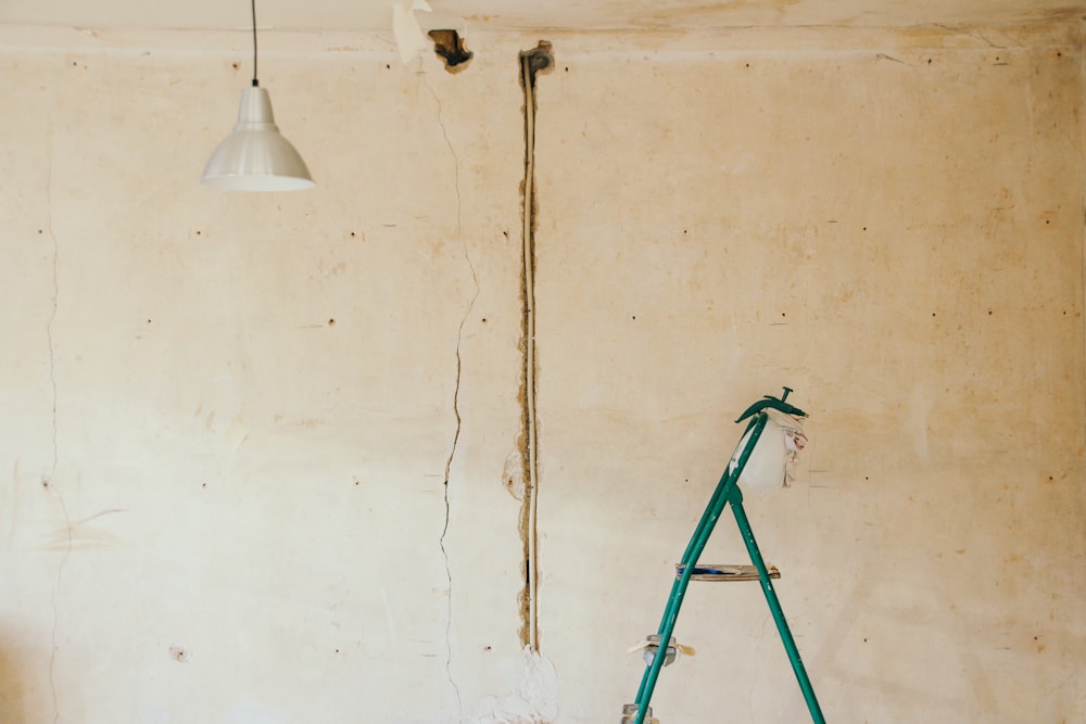 gray pendant lamp beside wall