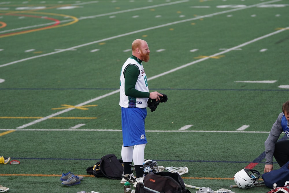 man holding helmet on field