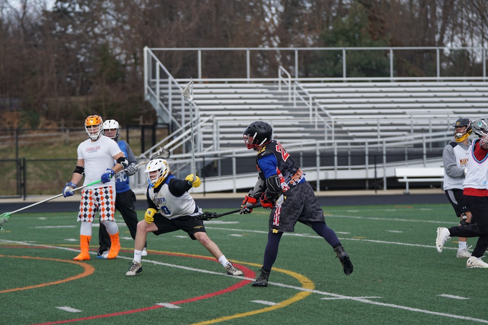 men playing lacrosse on field