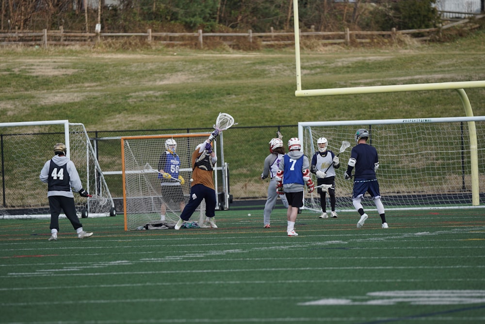 people playing lacrosse game on field