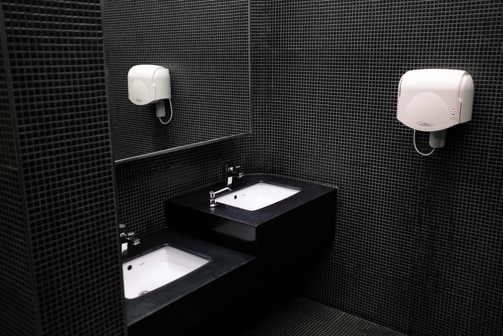 black and ceramic sink near hand dryer