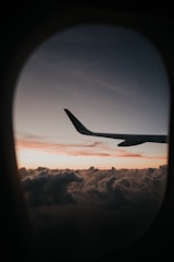 passenger plane flying over clouds