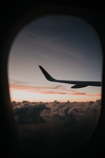 passenger plane flying over clouds