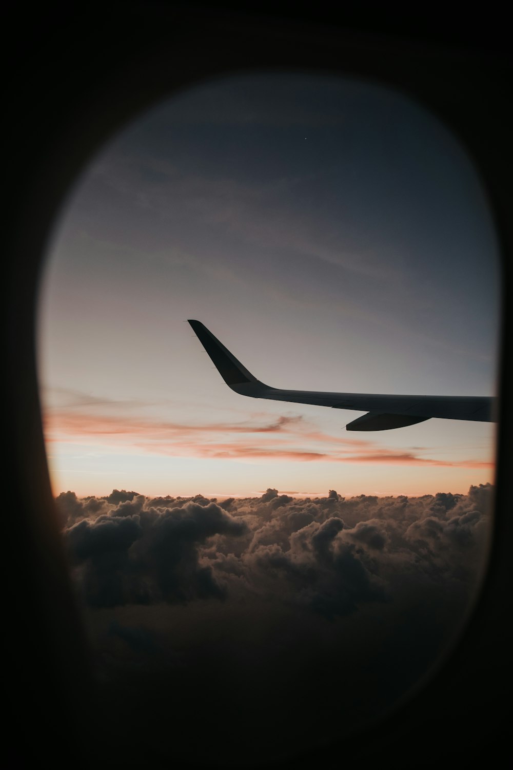 passenger plane flying over clouds