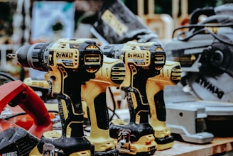 yellow Dewalt hand drills on table