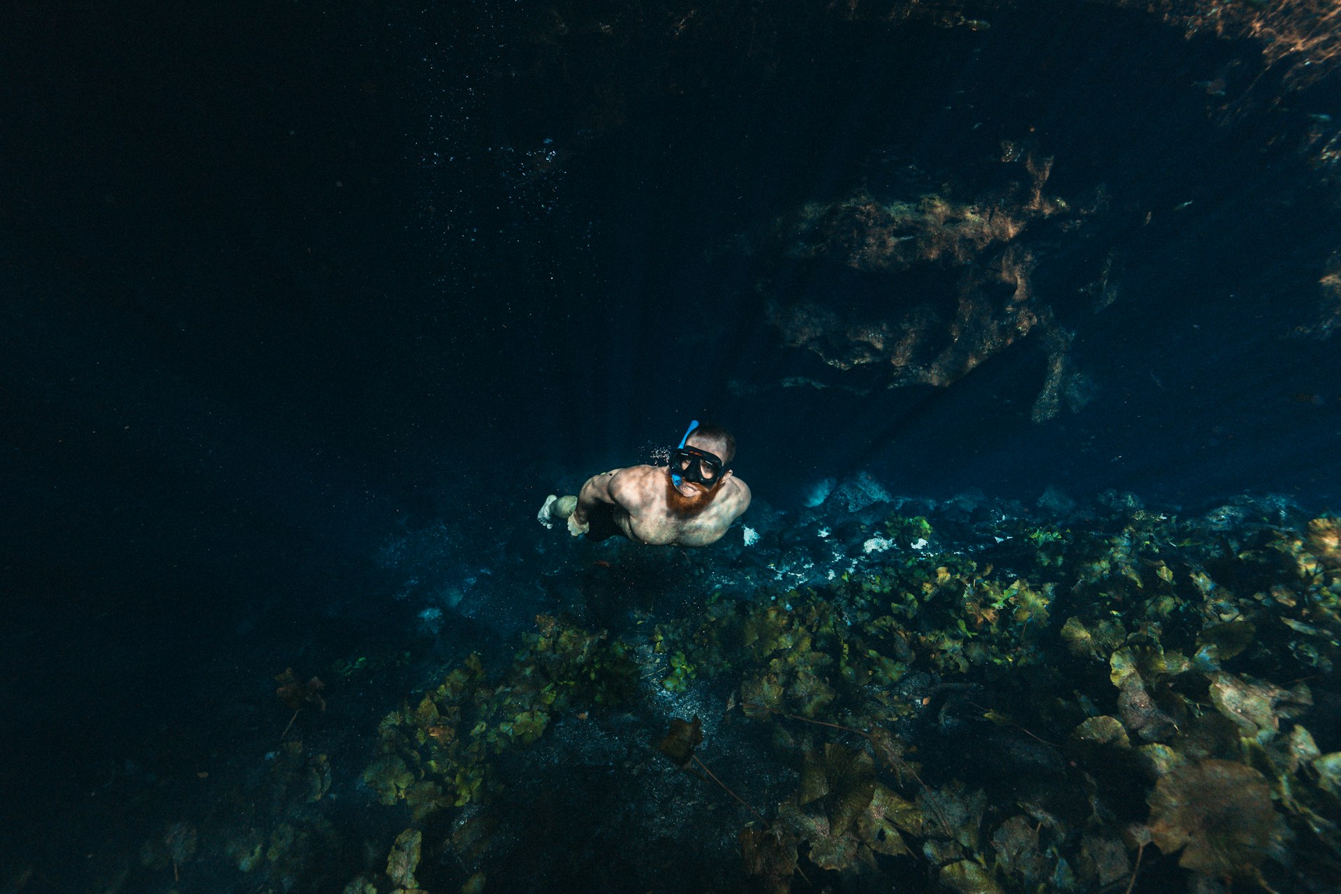 man free diving in clear water