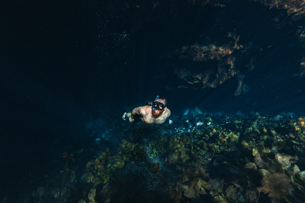 man free diving in clear water