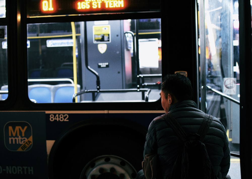 man standing in front of bus