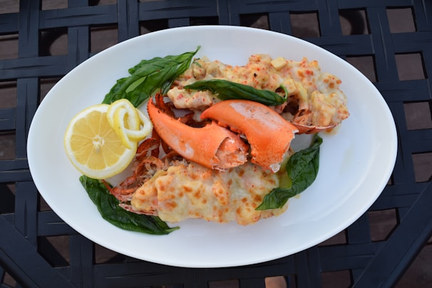 Artfully plated lobster mac and cheese with a golden crust and fresh parsley garnish