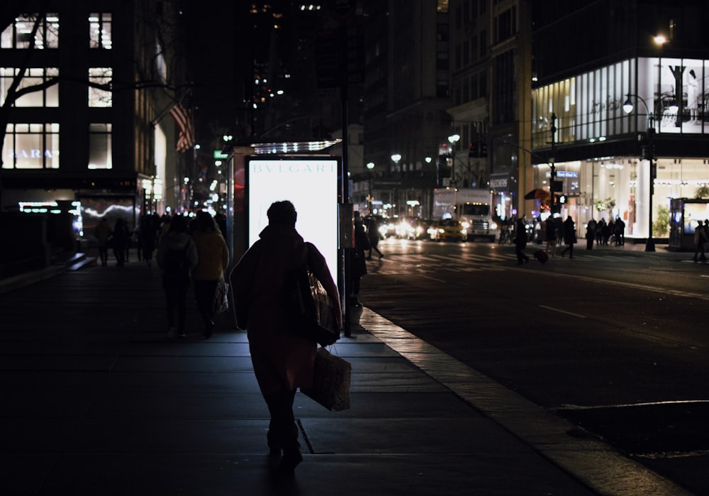 people walking on dark street