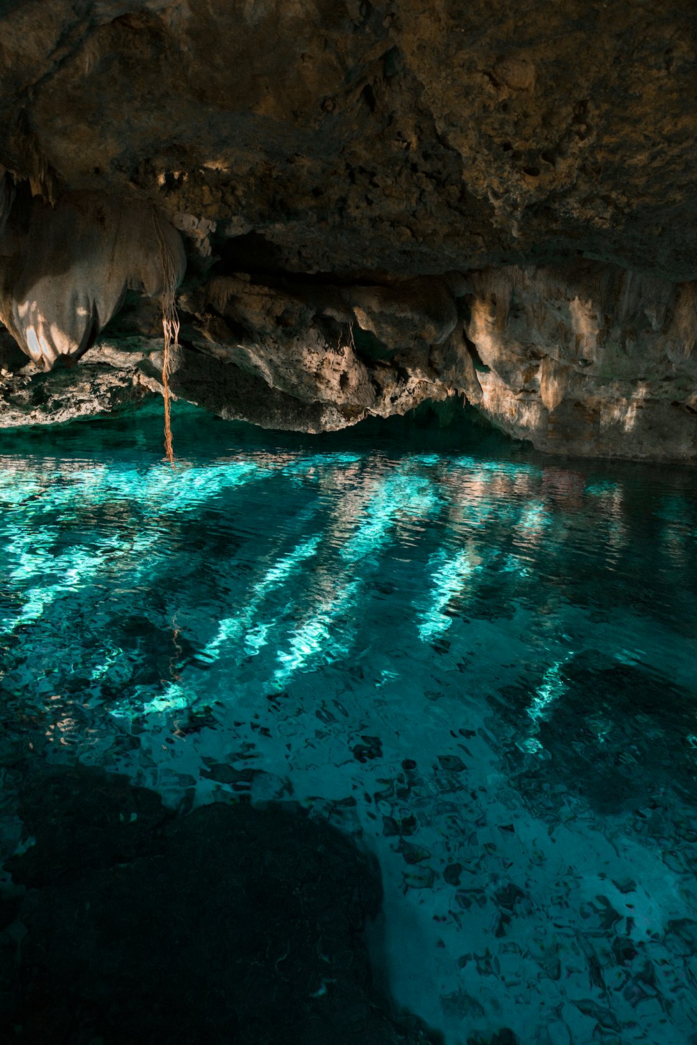 body of water under cave