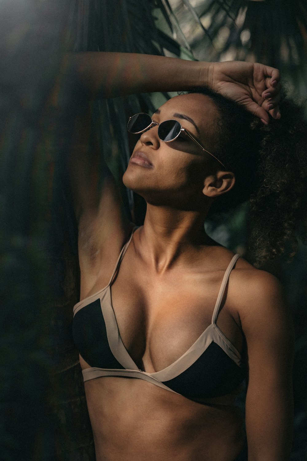 woman wearing black and grey bikini and black framed eyeglasses