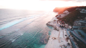 Aerial view of beautiful beachfront properties along the Oaxaca coast at sunset.