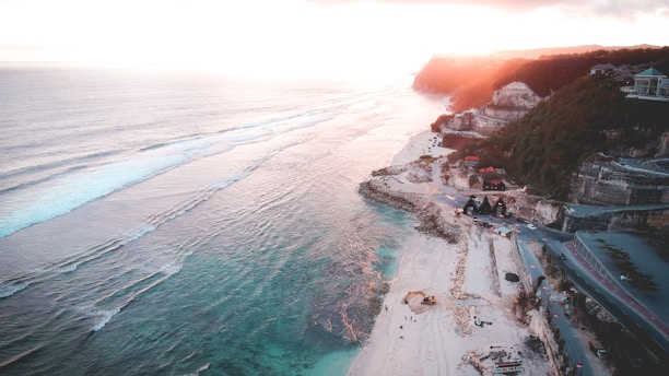 Aerial view of luxury beachfront properties along Santa Catarina coast at sunset.