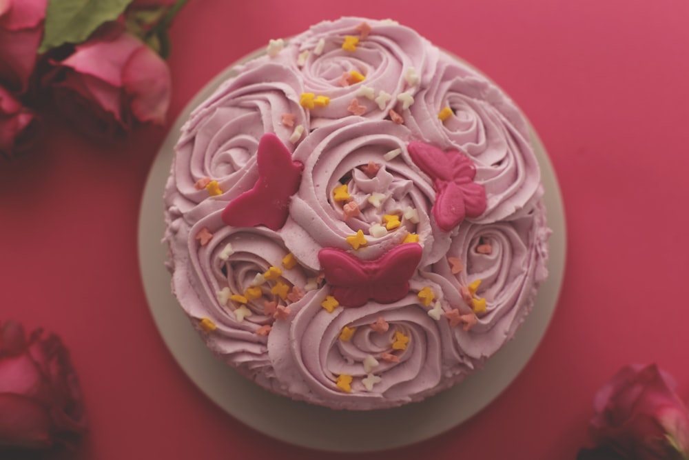 flat-lat photography of pink-icing colored rosette cake