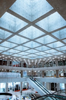 Elevator interior with multiple screens showcasing different brand ads in a modern skyscraper
