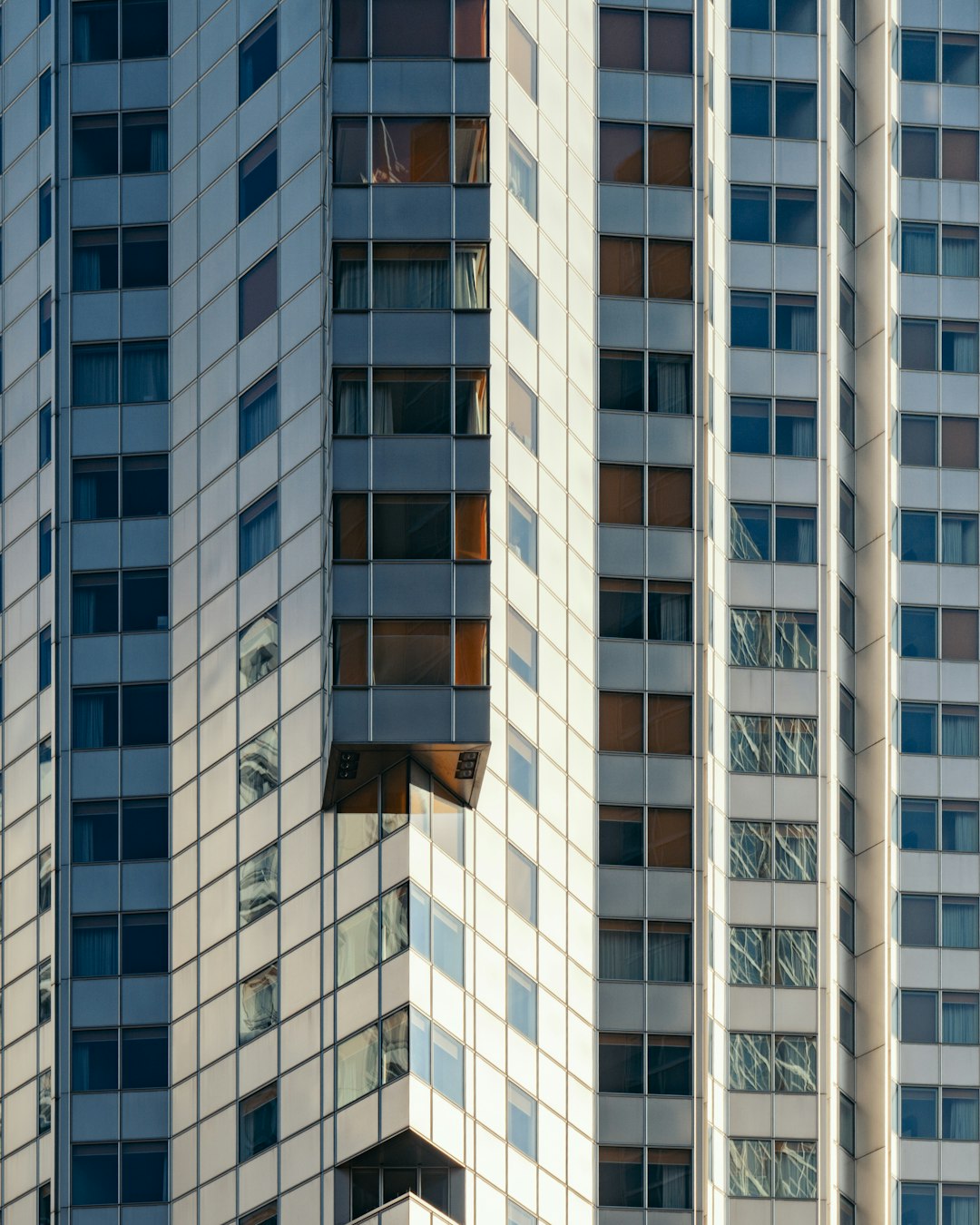 white and clear curtain wall building during daytime