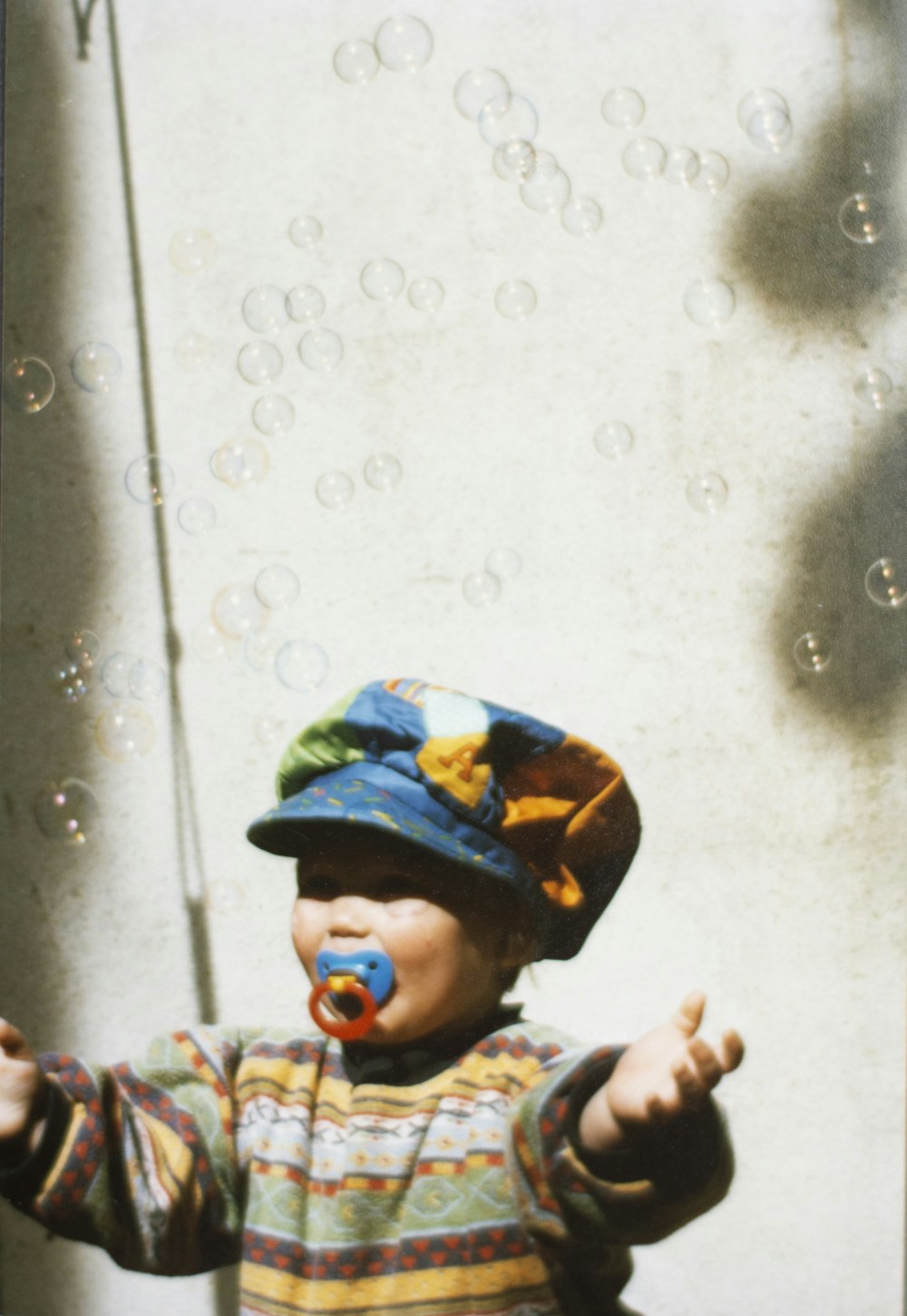 toddler standing near wall