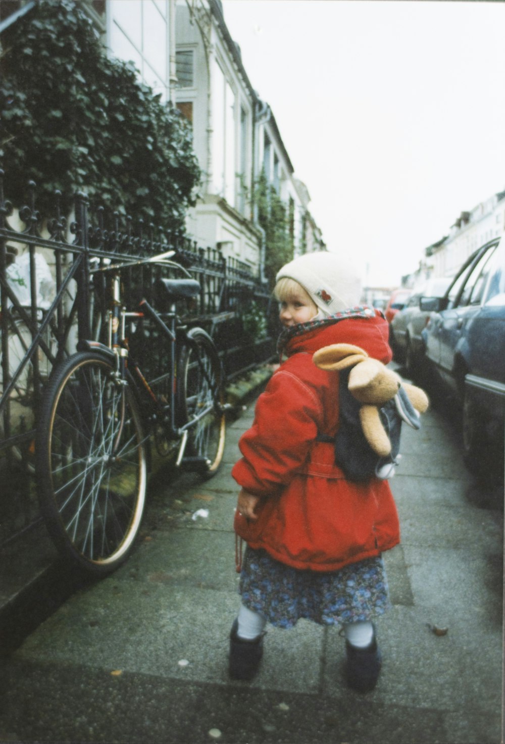 girl wearing red jacket near vehicles