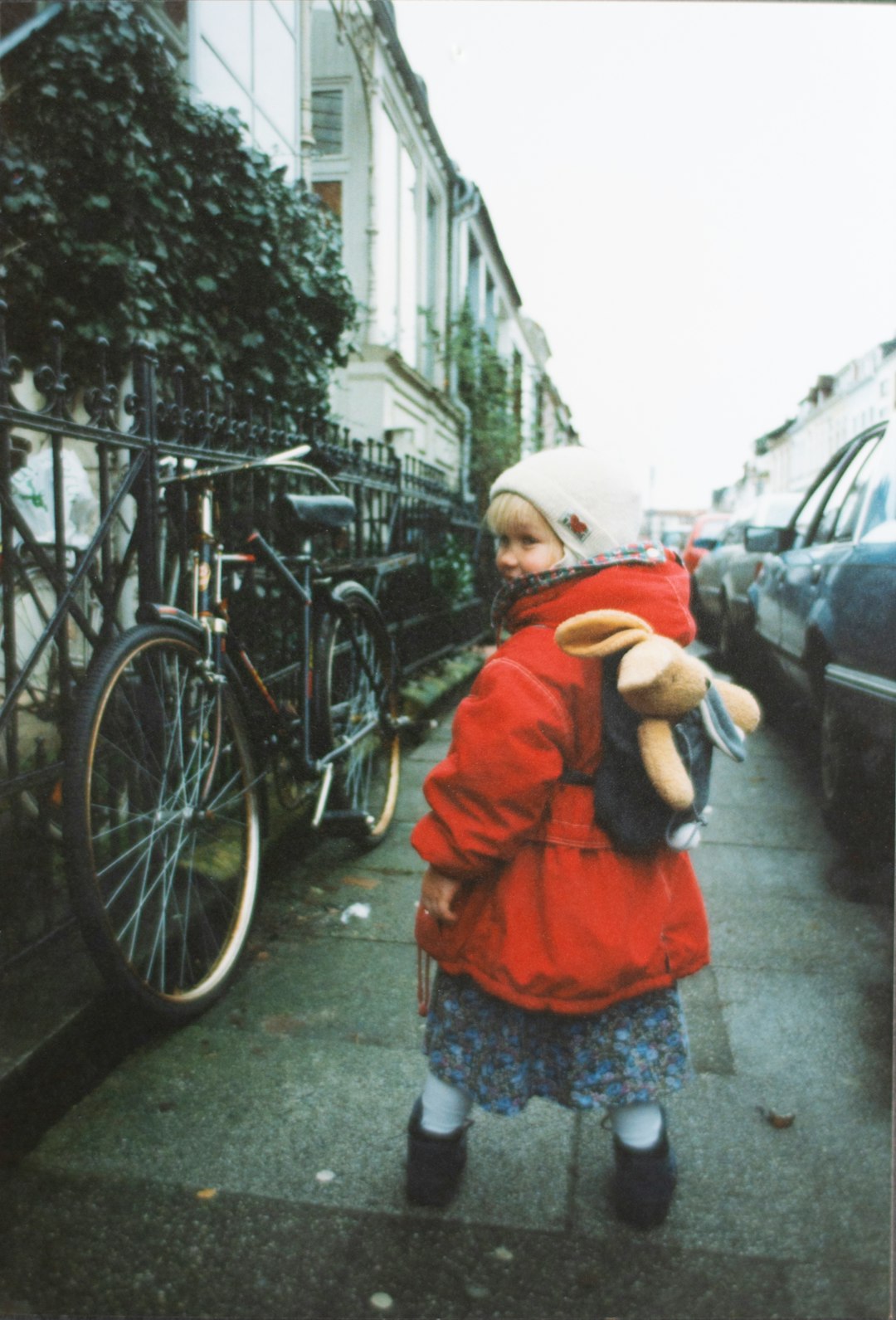 girl wearing red jacket near vehicles