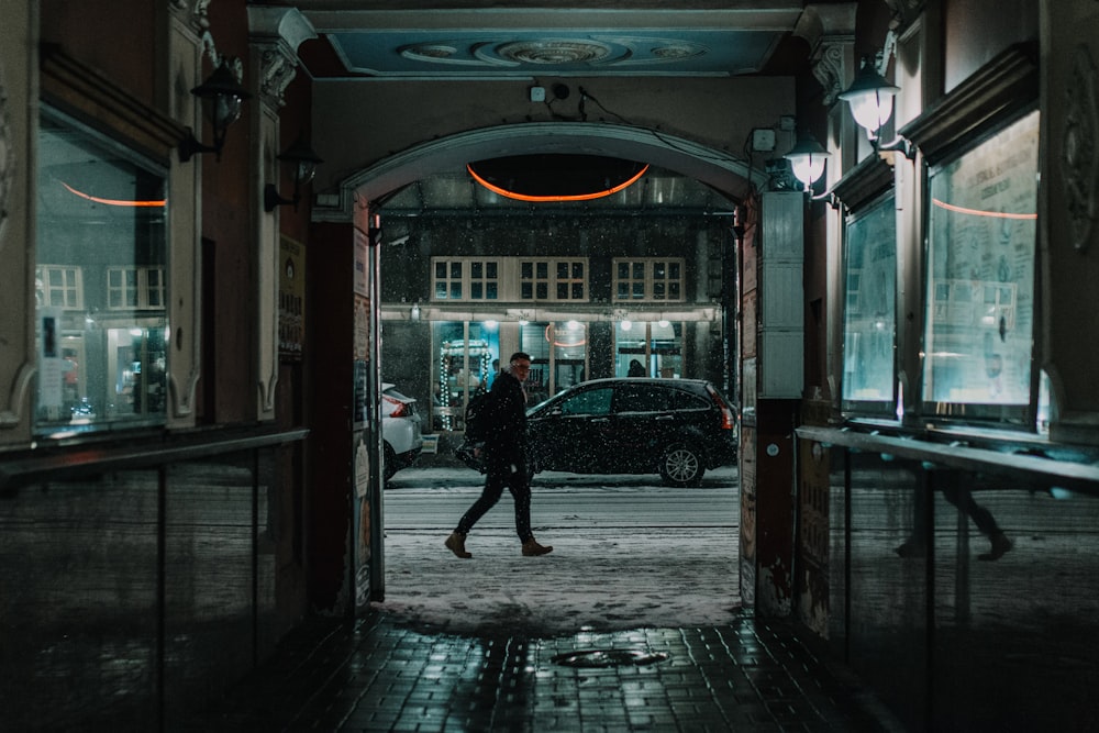 man walking beside building