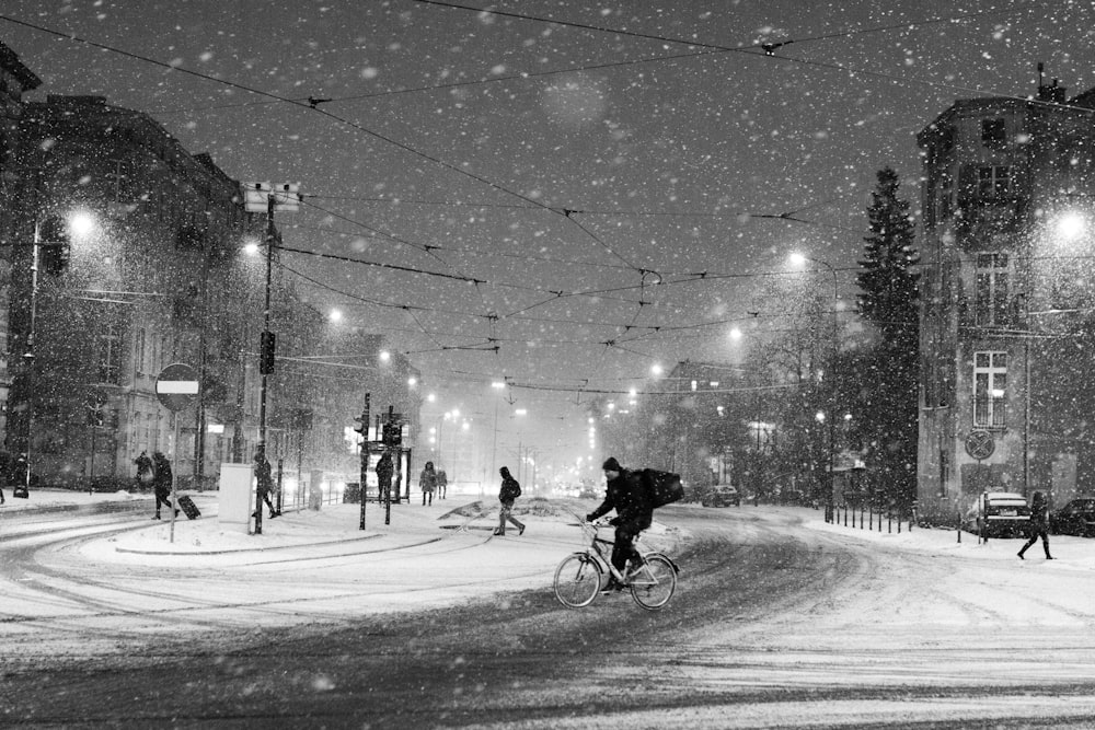 grayscale photography of person riding on bicycle