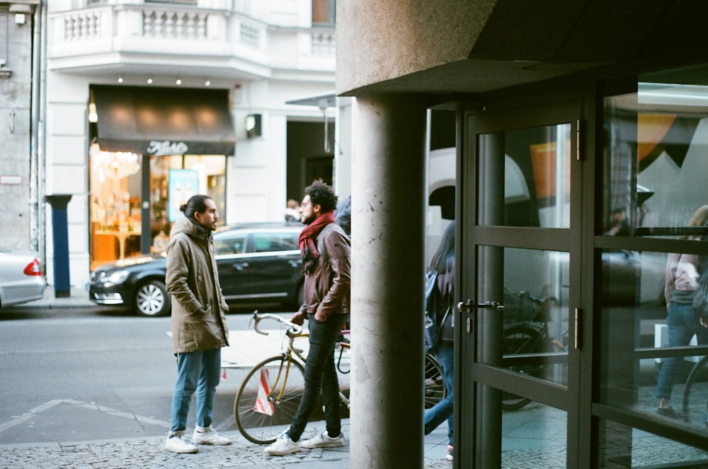 men talking beside road