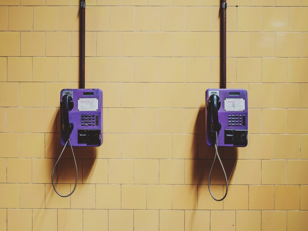 two purple wall telephones