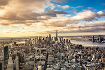 An aerial shot of a bustling city skyline blending with an open sky to suggest global connections.