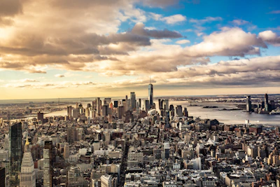 An aerial shot of a bustling city skyline blending with an open sky to suggest global connections.