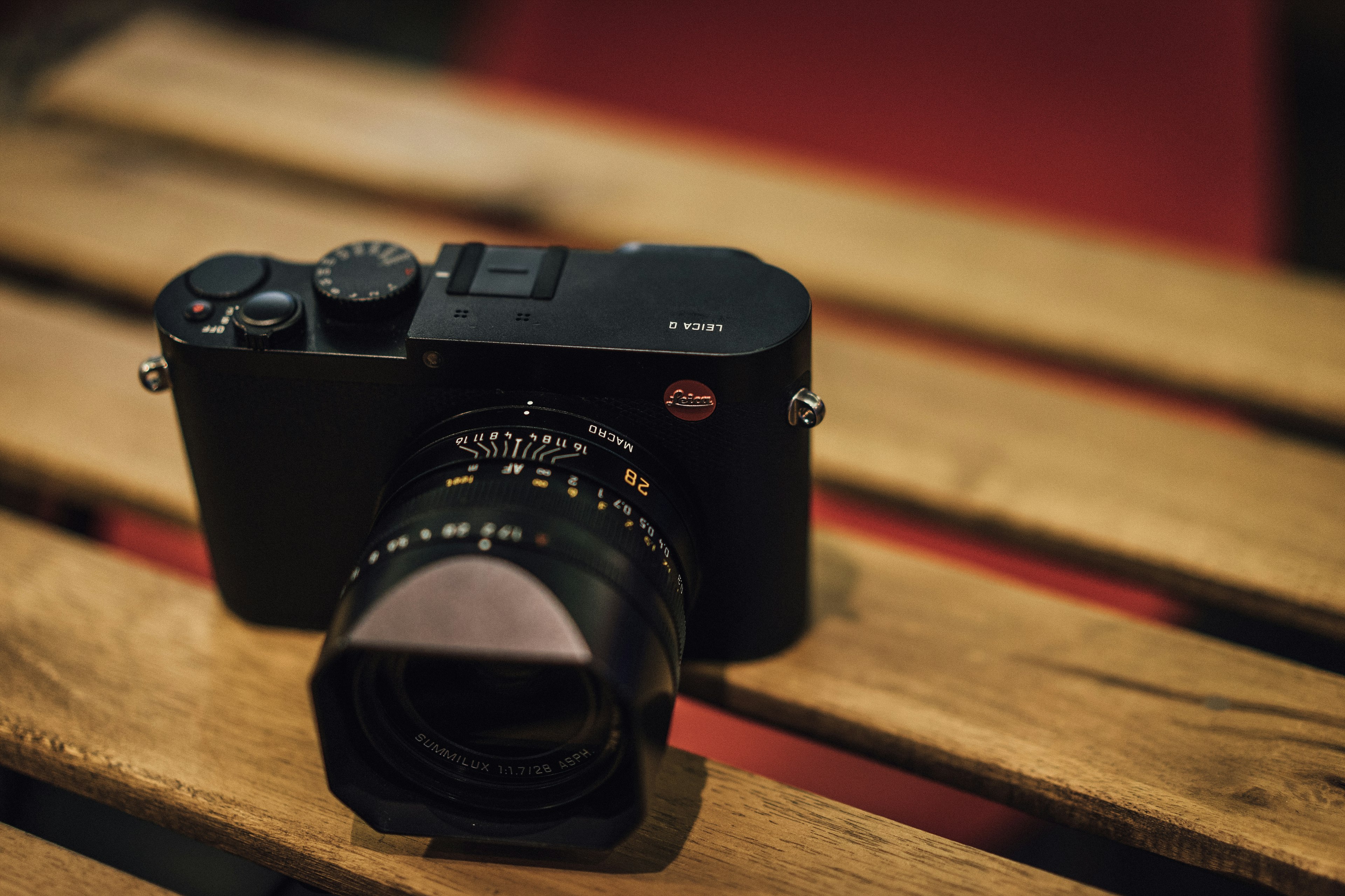 black SLR camera on wooden bench