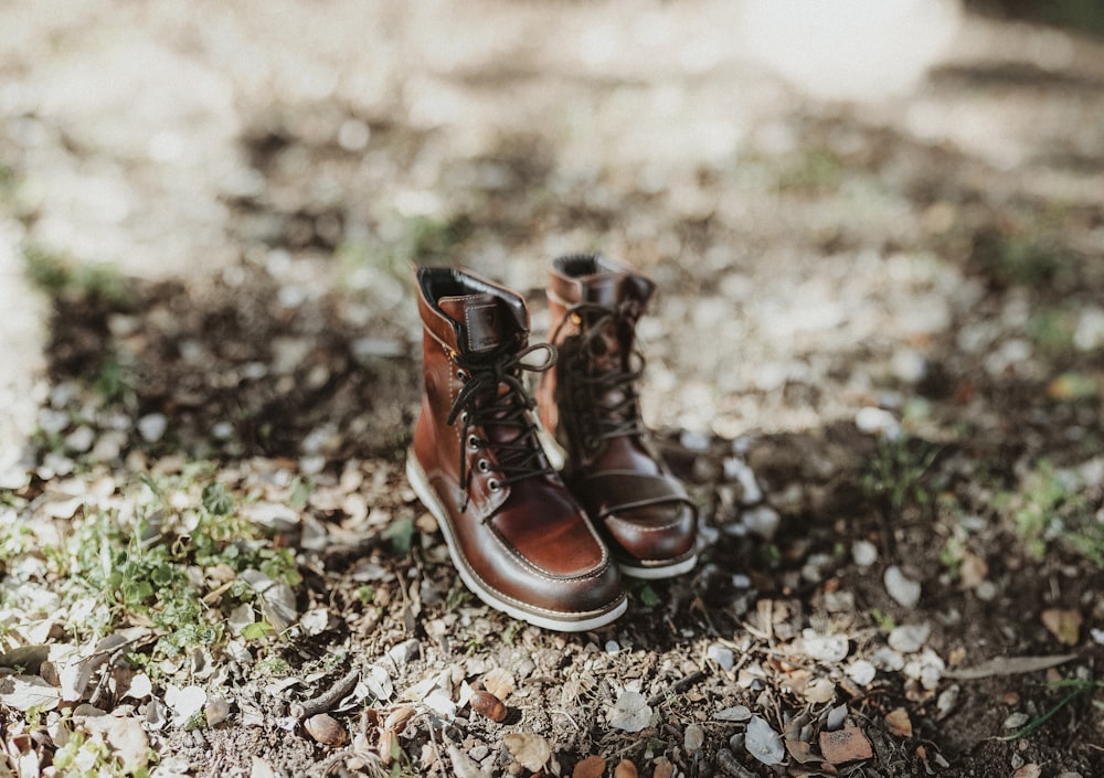 pair of brown leather boots on ground during daytime