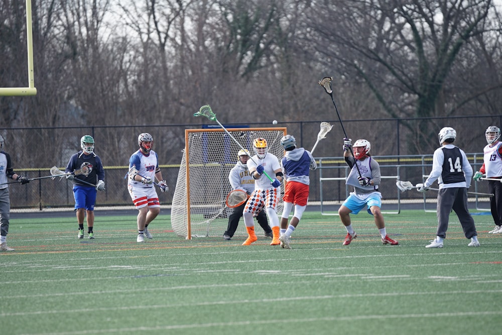 people playing lacrosse on field