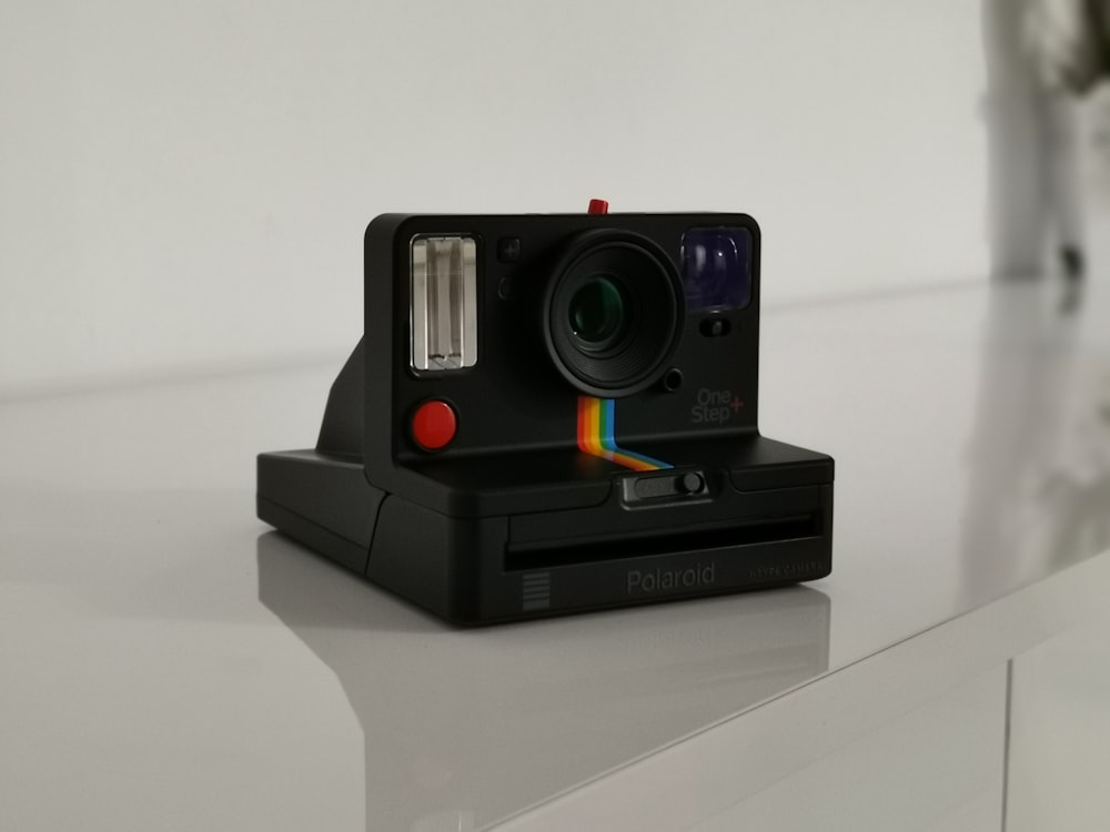 black Polaroid camera on table