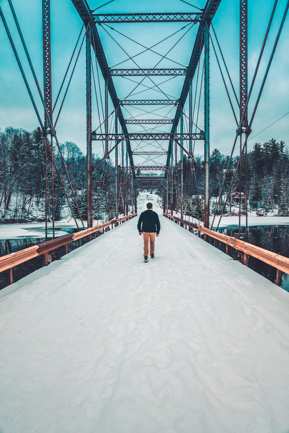 man walking on bridge during daytime