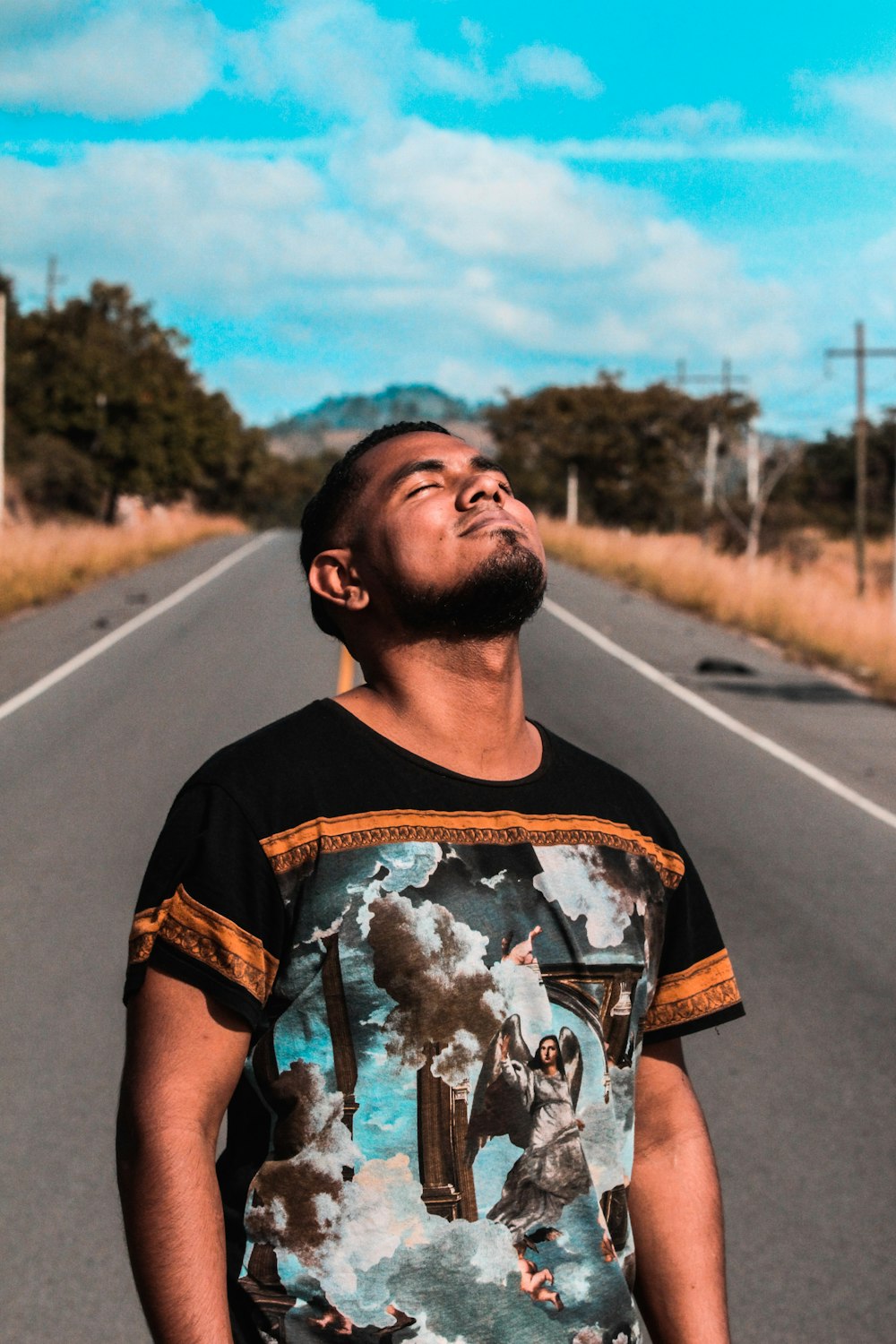 man standing on road during daytime