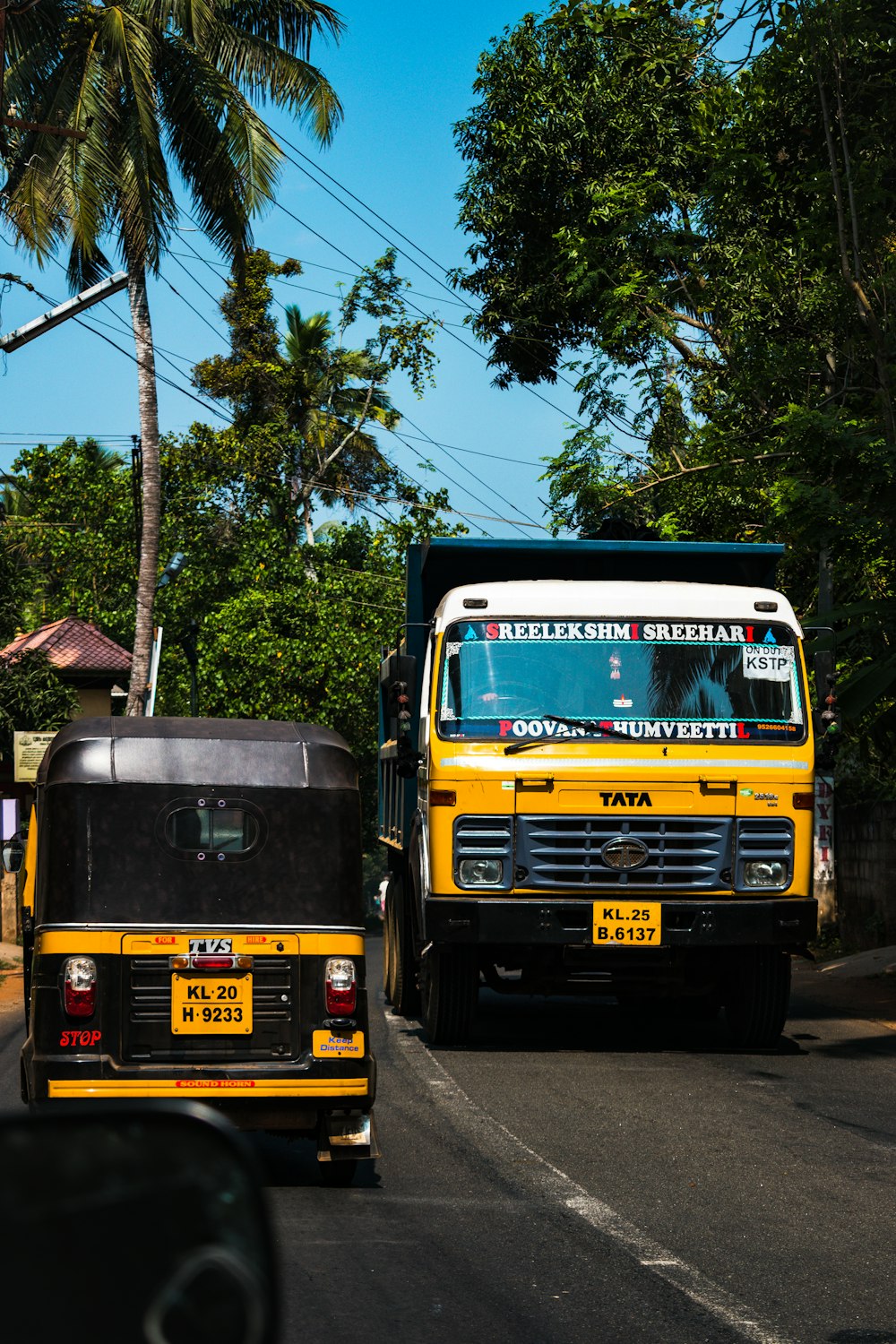 black and yellow auto rickshaw on road