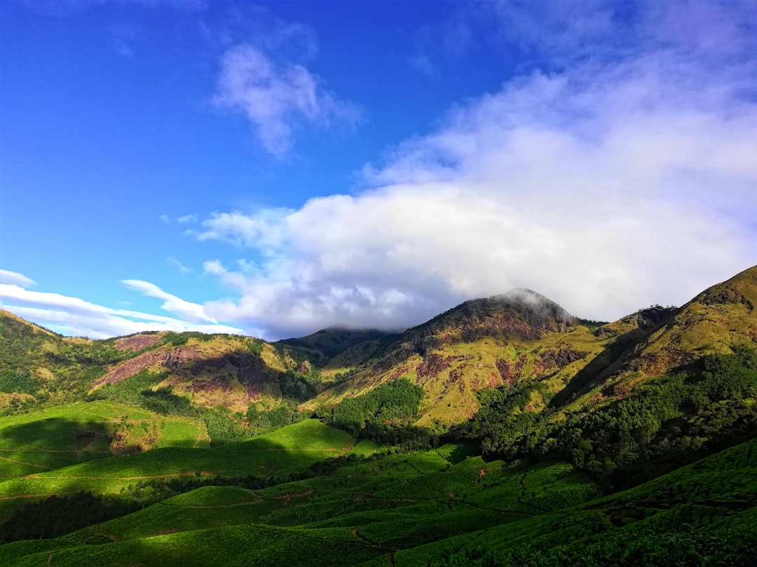 green mountain hill under blue sky,