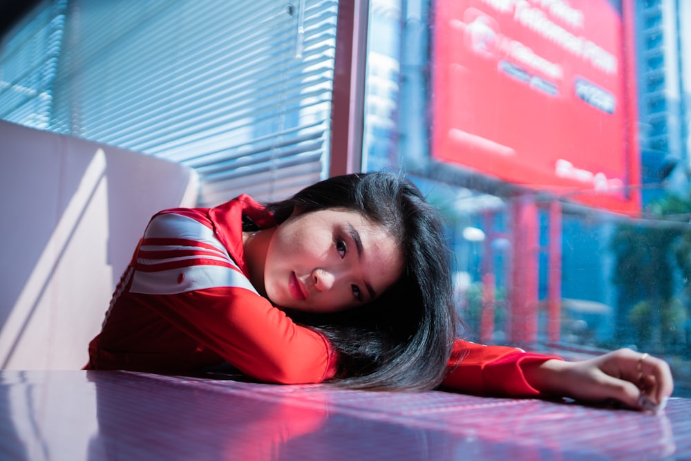 woman laying on table during daytime
