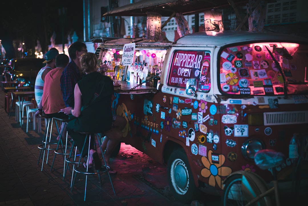 men sitting in front of Volkswagen van