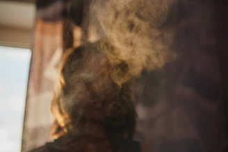 A woman hugging someone who is fading away into smoke, set in a heavy emotional atmosphere with a dark background and an expression of abandonment, in premium cinematic art style.