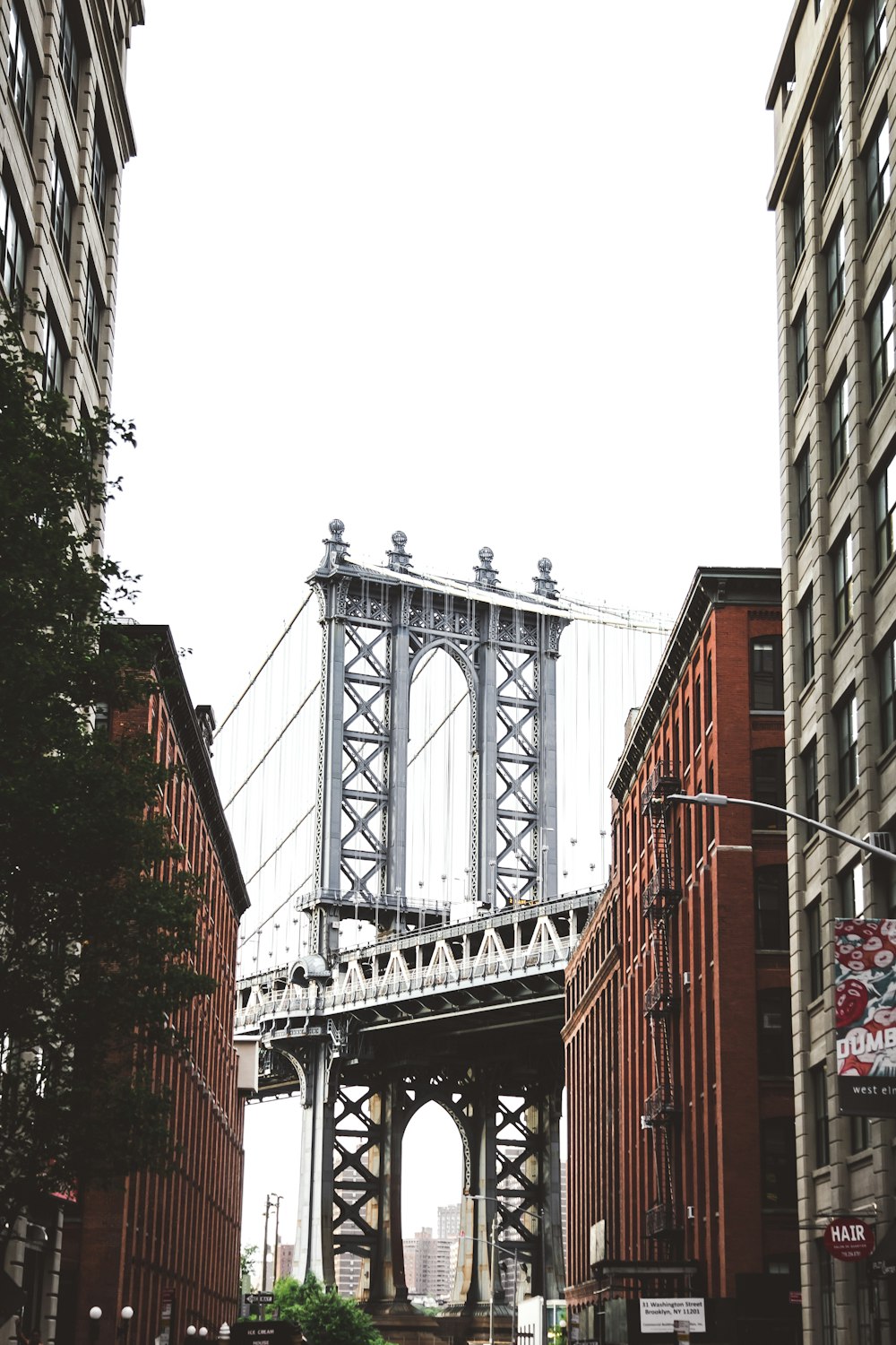 bridge near building under white sky