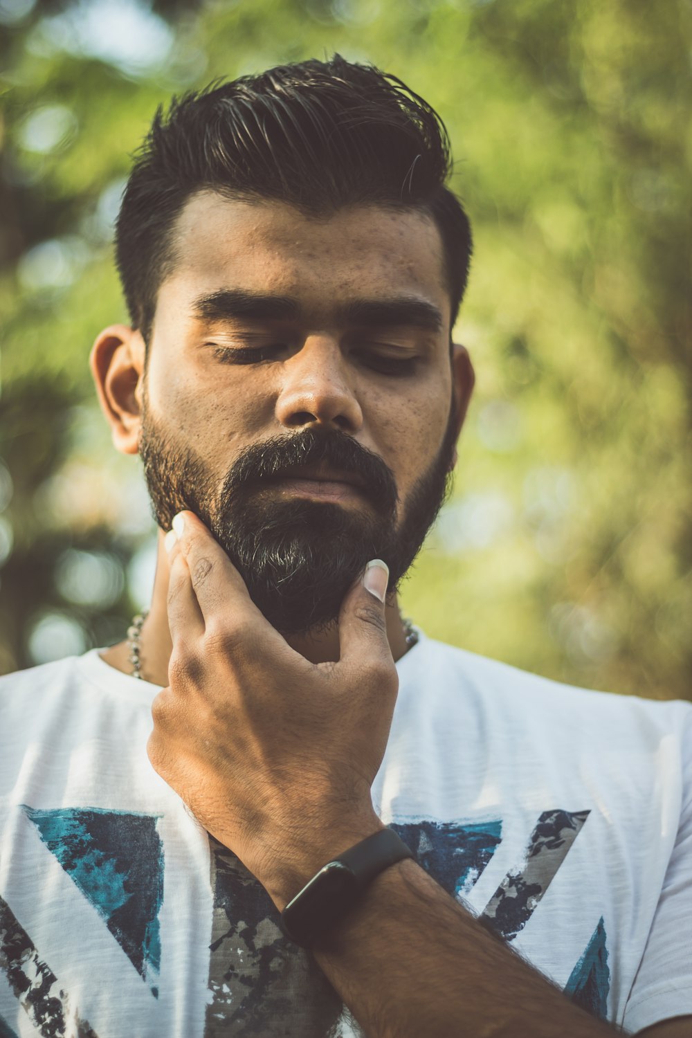 man holding his facial hair