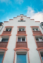 low-angle photography of white and brown concrete multi-story building during daytime