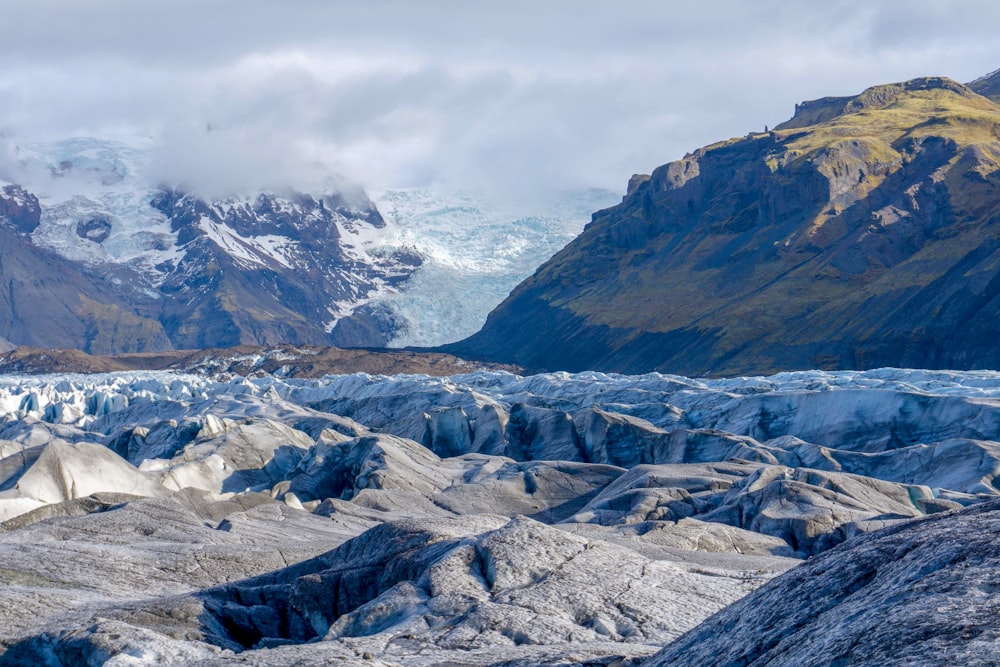 glaciers by mountains during daytime