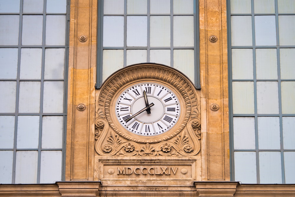 brown wooden framed analog clock